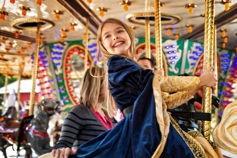 Girl in costume on carrousel. 