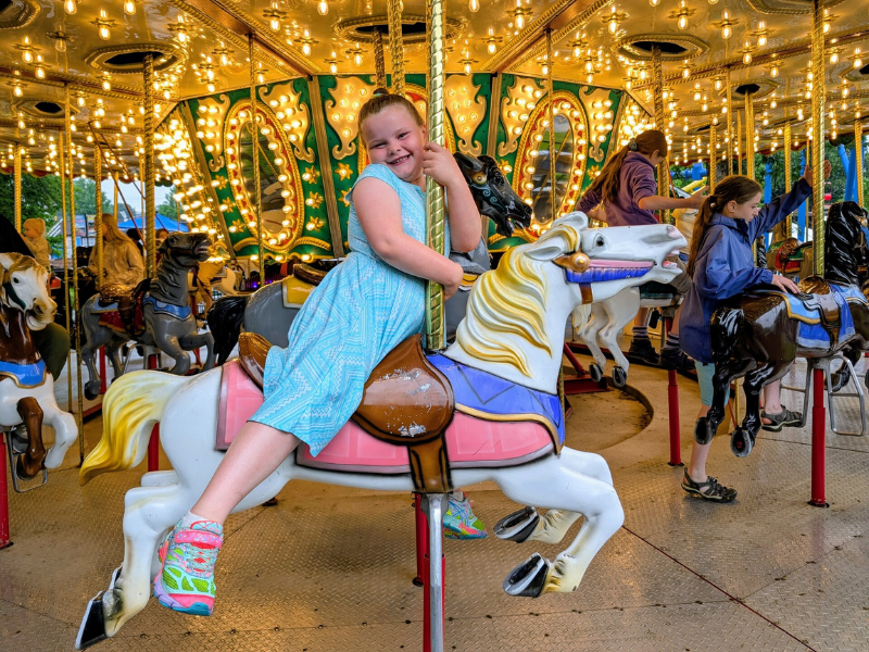 girl on a carousel horse