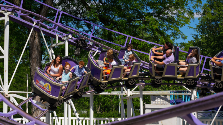 Guests riding Kingdom Coaster