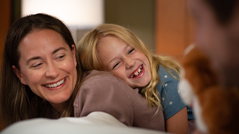 mom and daughter laughing